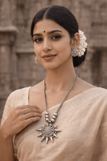 Sunburst oxidized silver necklace with floral earrings